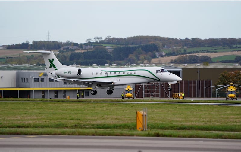 The plane carrying the body of former first minister of Scotland Alex Salmond lands at Aberdeen Airport