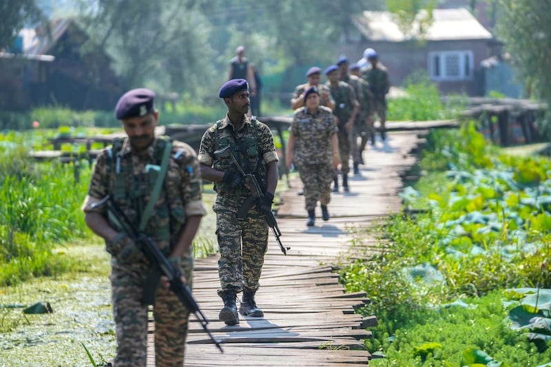 Indian soldiers on patrol during the second phase of the assembly election in Srinagar, Indian controlled Kashmir (Mukhtar Khan/AP)