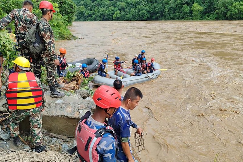 Rescuers have yet to find any trace of the two missing buses in the Trishuli river, which is murky brown and swollen from heavy monsoon rains (Nepal Armed Police Force/AP)