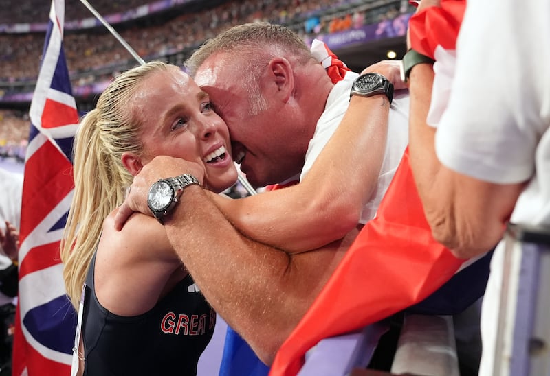 Keely Hodgkinson hugs her father Dean after the race