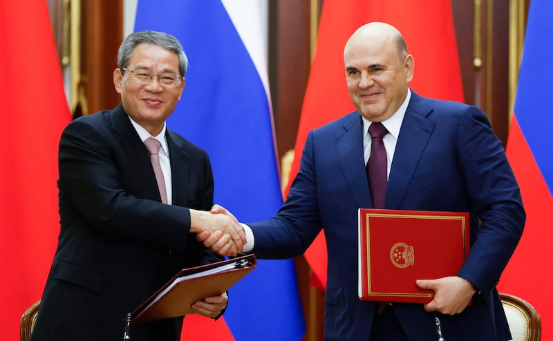 Chinese Premier Li Qiang and Russian Prime Minister Mikhail Mishustin shake hands during a signing ceremony (Dmitry Astakhov/Sputnik/Kremlin Pool Photo/AP)