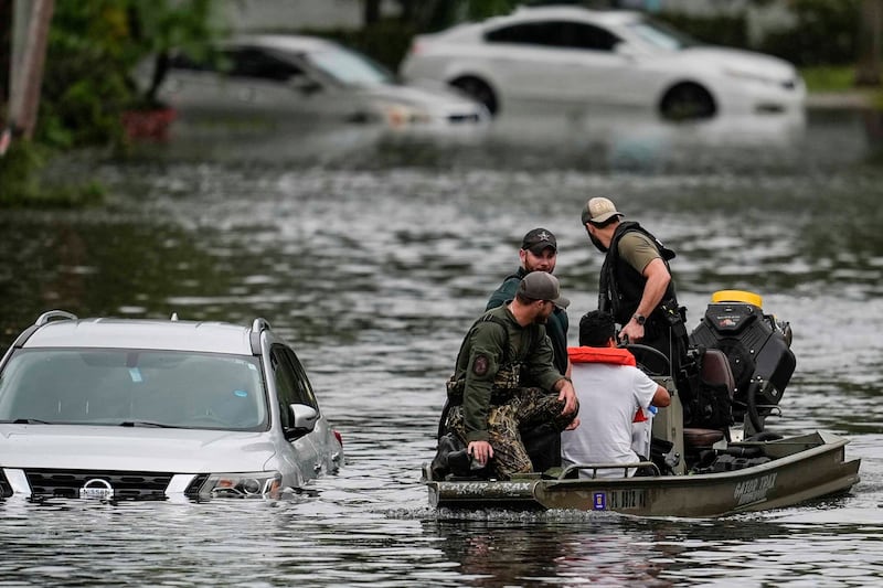 People are rescued from an apartment complex in Clearwater (Mike Stewart/AP)