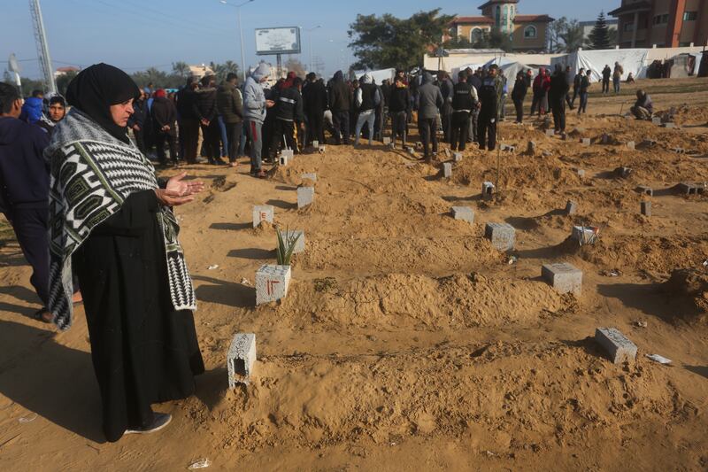 A Palestinian woman prays for a relative killed in the Israeli bombardment of the Gaza Strip in Khan Younis on Monday (Hatem Ali/AP)