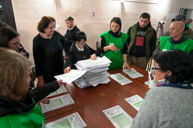 Members of an election commission count ballots at a polling station in Tbilisi, Georgia (Kostya Manenkov/AP)