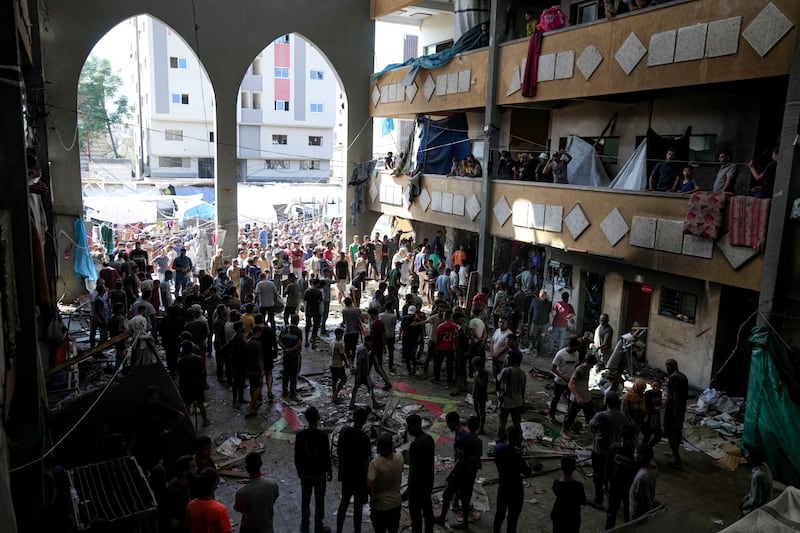 Palestinians inspect the damage to the school (Abdel Kareem Hana/AP)