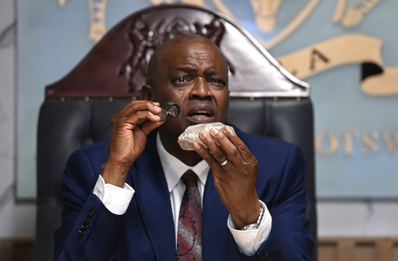 Botswana’s President Mokgweetsi Masisi holds the 2,492-carat diamond that was unearthed at one of the country’s mines (AP)