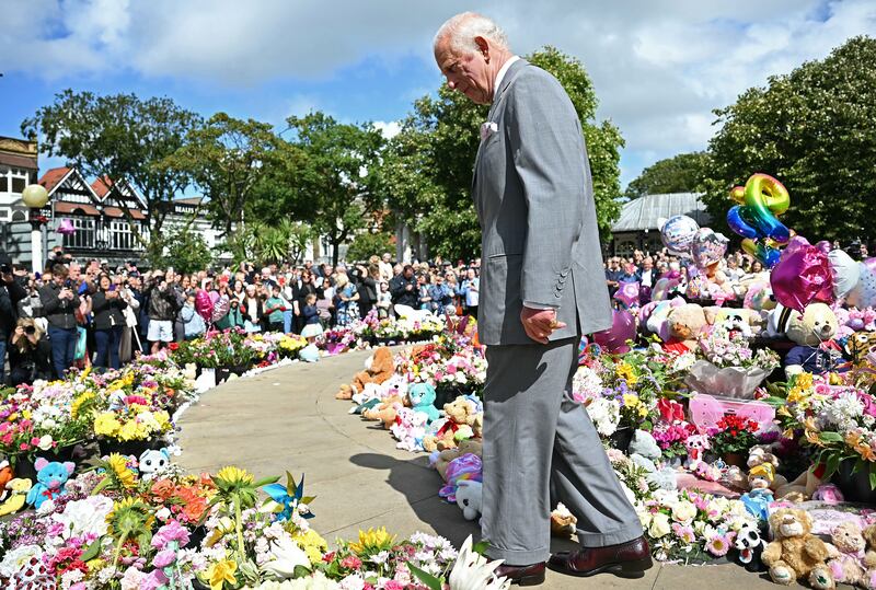 Charles walked among hundreds of bunches of flowers and cuddly toys left as tributes