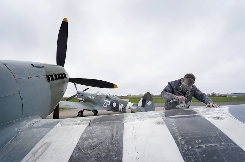 An engineer works to prepare a Spitfire outside the Heritage Hangar at Biggin Hill Airport in Kent, ahead of the 80th anniversary of D-Day in June. .