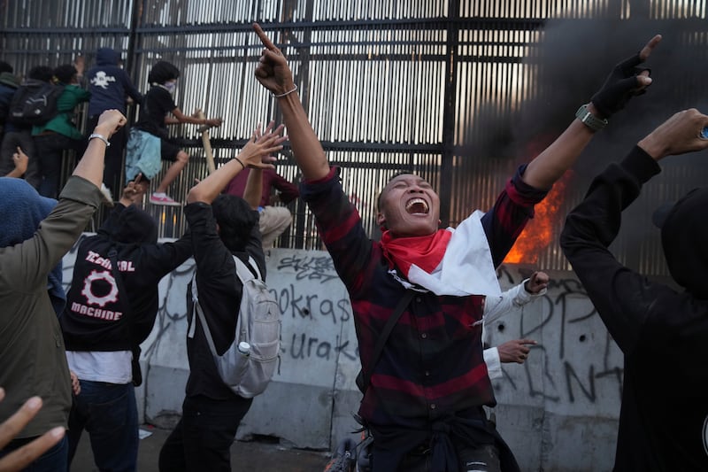 Some protesters in Jakarta tore down a section of fence and threw it at police (AP Photo/Dita Alangkara)