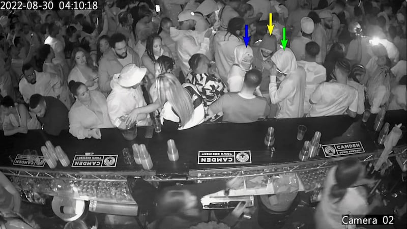 CCTV still of a masked man said to be Chris Kaba (blue arrow) with two co-defendants Connel Bamgboye, 29, (green arrow) and Shemiah Bell, 32, (yellow arrow) in the Oval nightclub before the shooting.