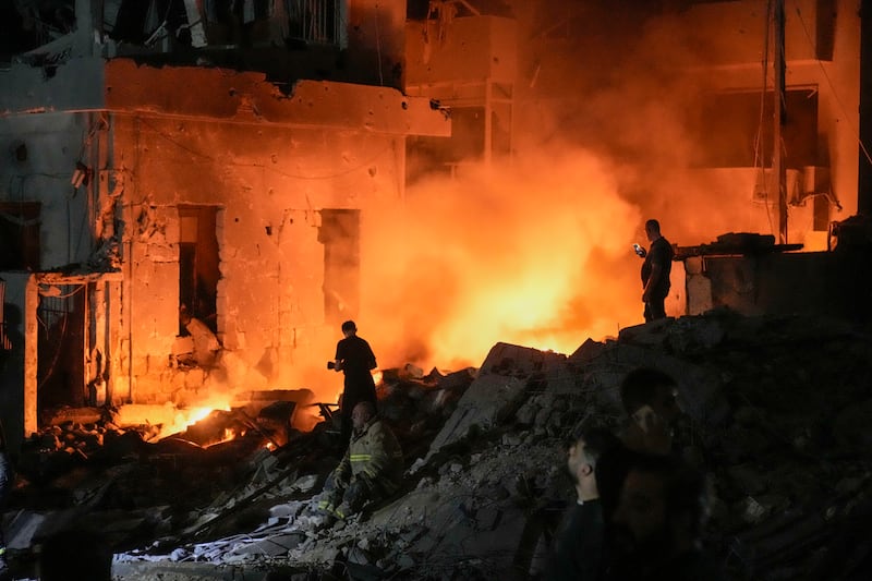 Flames and smoke rise after buildings were hit by an Israeli air strike in central Beirut (Bilal Hussein/AP)