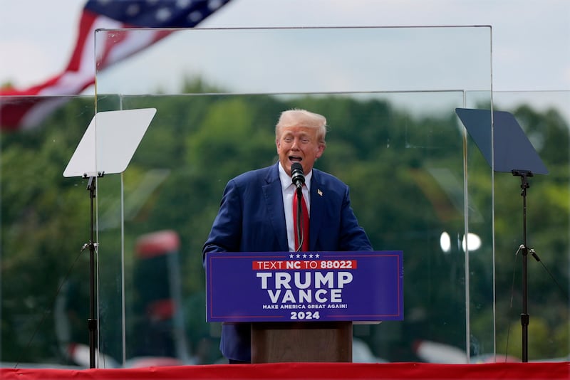 Donald Trump speaks behind bulletproof glass during a campaign rally at North Carolina Aviation Museum (Julia Nikhinson/AP)