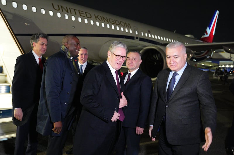 Prime Minister Sir Keir Starmer (centre), Foreign Secretary David Lammy (second left) and Energy Secretary Ed Miliband (left) arrive at Heydar Aliyev International Airport