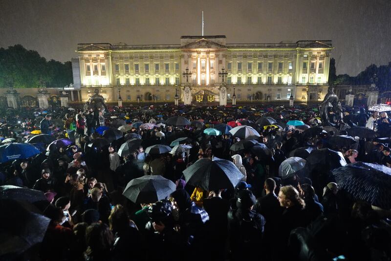 Members of the public gather outside Buckingham Palace on the day the Queen died