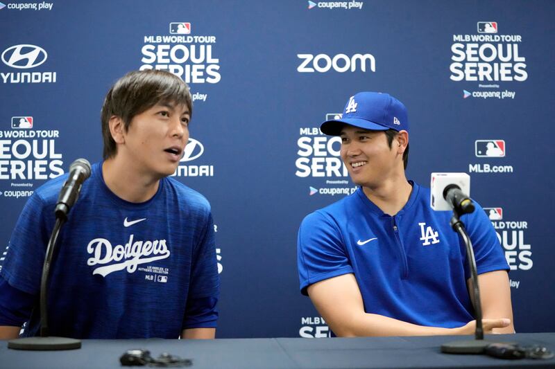 Los Angeles Dodgers’ Shohei Ohtani, right, and his interpreter Ippei Mizuhara attend a news conference ahead of a baseball workout at Gocheok Sky Dome in Seoul (Lee Jin-man/AP)