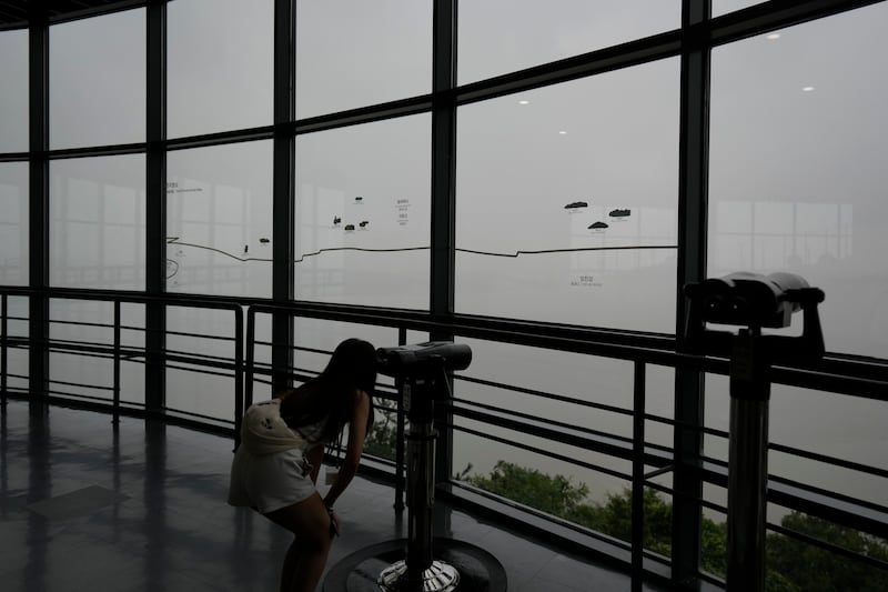 A visitor uses binoculars to see the North Korean side from the unification observatory in Paju, South Korea (Lee Jin-man/AP)