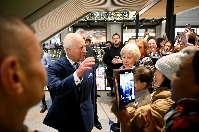 The King speaking with well-wishers during a visit to the Curated Makers Christmas Market inside Battersea Power Station