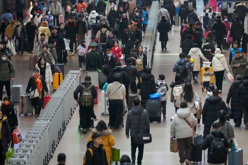 Travellers are streaming into the departure hall to catch their trains at the Beijing West Railway Station (AP)