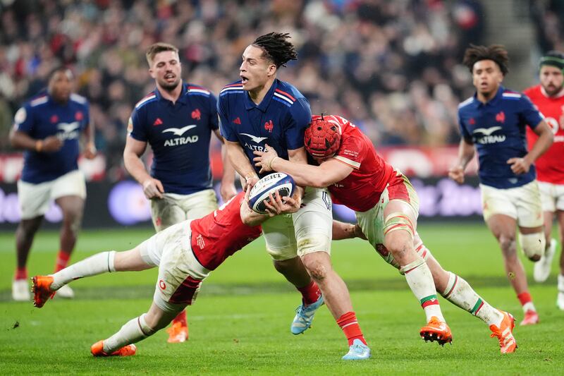 France’s Mickael Guillard (centre) is tackled by Wales’ Liam Williams