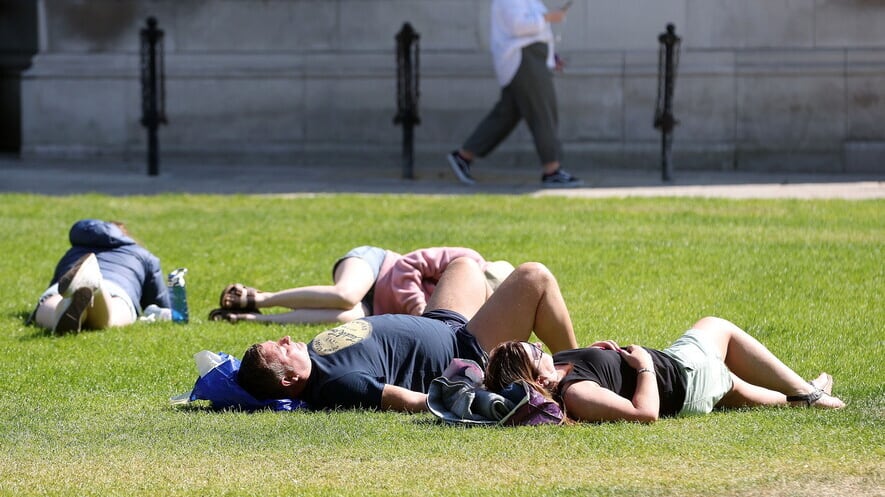 Sunbathers at Belfast City Hall at the beginning of June. Picture by Mal McCann