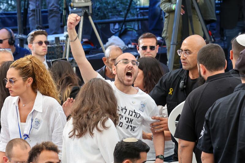 A man shouts as Israeli Prime Minister Benjamin Netanyahu speaks during a ceremony at the Mount Herzl military cemetery in Jerusalem (Gil Cohen-Magen/Pool Photo via AP)