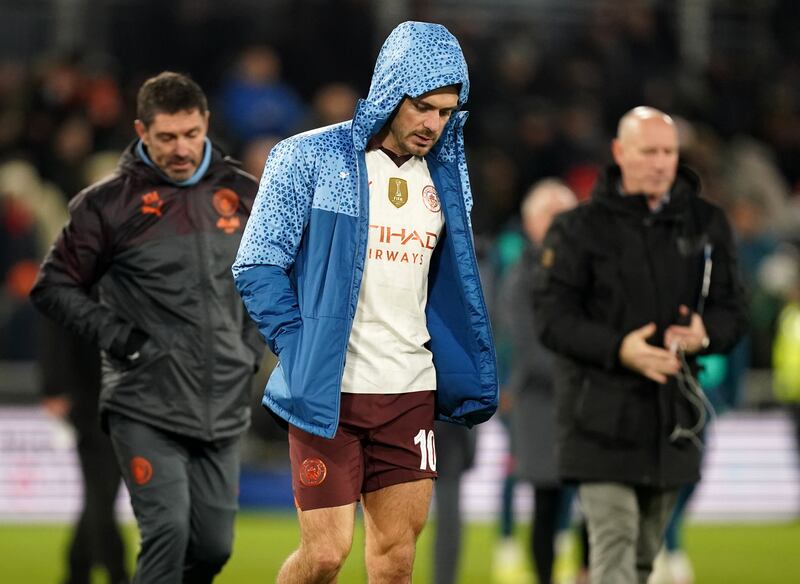 Manchester City’s Jack Grealish looks dejected as he walks across the pitch at half time after being substituted
