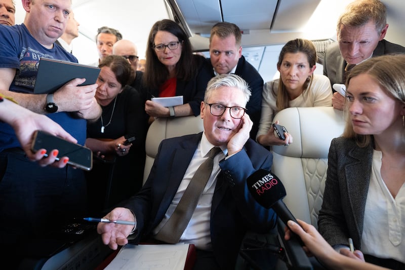 Prime Minister Sir Keir Starmer talks to journalists on the plane to Washington for the Nato summit