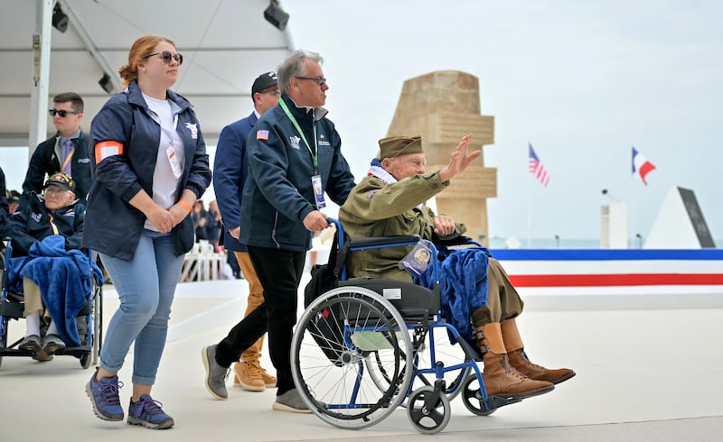 US Second World War veteran Andre C Chappaz waves as he arrives at the official international ceremony to mark the 80th anniversary of D-Day, at Omaha Beach in Saint-Laurent-sur-Mer, Normandy, France