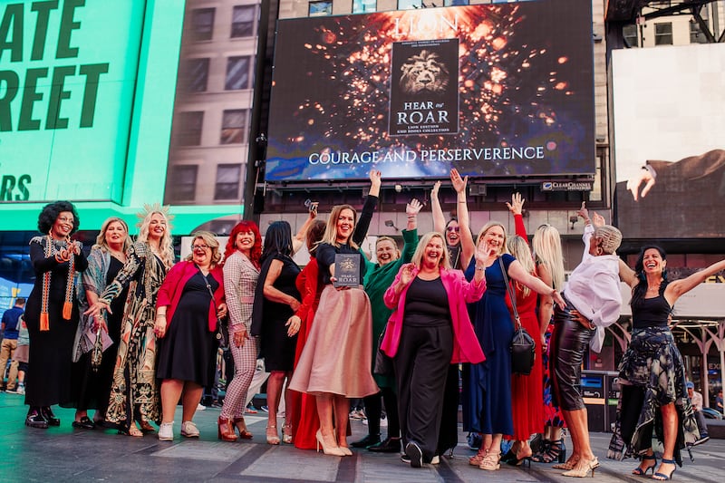 The Voices of Seven trade mission celebrate in Times Square. PICTURE: LISA MITTEN