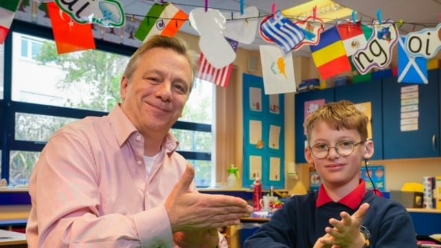 Mark Baker, Chief Executive, Controlled Schools’ Support Council with a pupil representing Cregagh Primary School – engaging with sign language