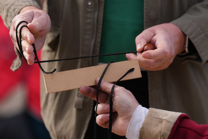 Conker string is measured as competitors take part in the annual World Conker Championships.