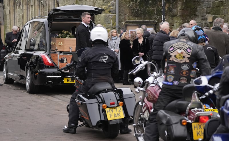 Harley Davidson riders gather behind the hearse to take part in a tribute following the funeral of DJ Johnnie Walker