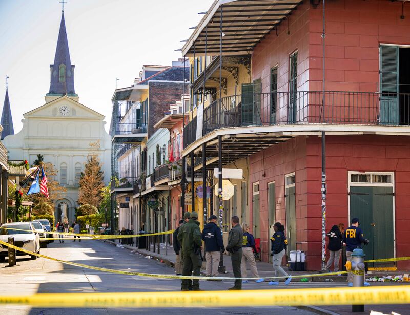 The FBI investigates the area on Orleans Street and Bourbon Street by St Louis Cathedral in the French Quarter (Matthew Hinton/AP)