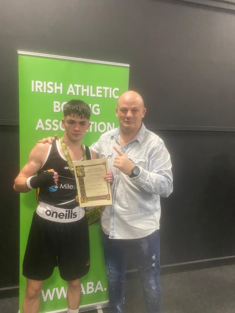 Donagh Keary receives his certificate from Irish referee and judge Seamus Kelly at the National Stadium