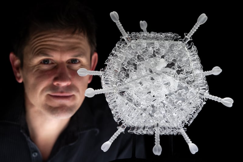 Luke Jerram pictured next to his glass sculpture of the Oxford/AstraZeneca vaccine