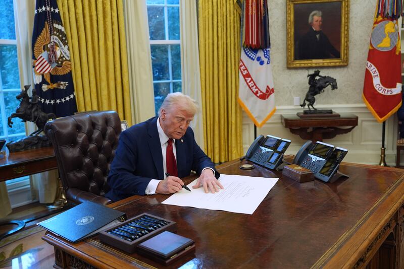 President Donald Trump signs executive orders in the Oval Office at the White House (AP Photo/Evan Vucci)