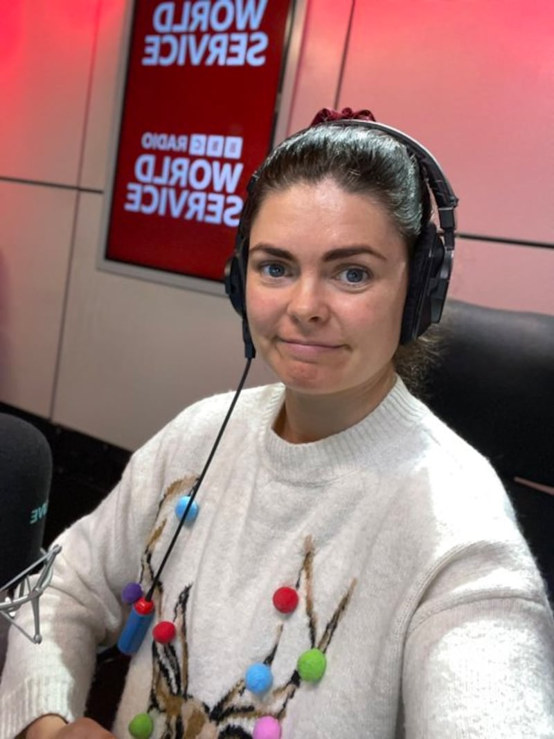 Leanna Byrne, sitting in a studio with headphones, is a presenter for BBC World Service's Marketplace Morning Report