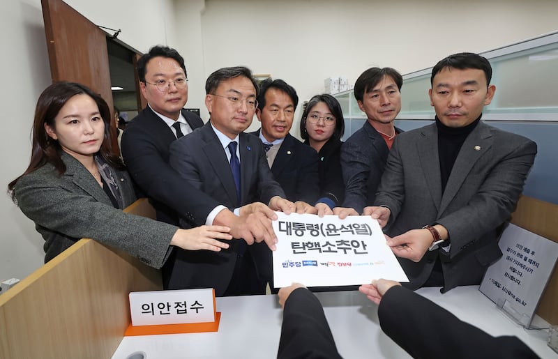 Members of the Democratic Party joined other minor opposition parties in submitting a bill to impeach President Yoon Suk Yeol (Ryu Hyung-seok/Yonhap via AP)