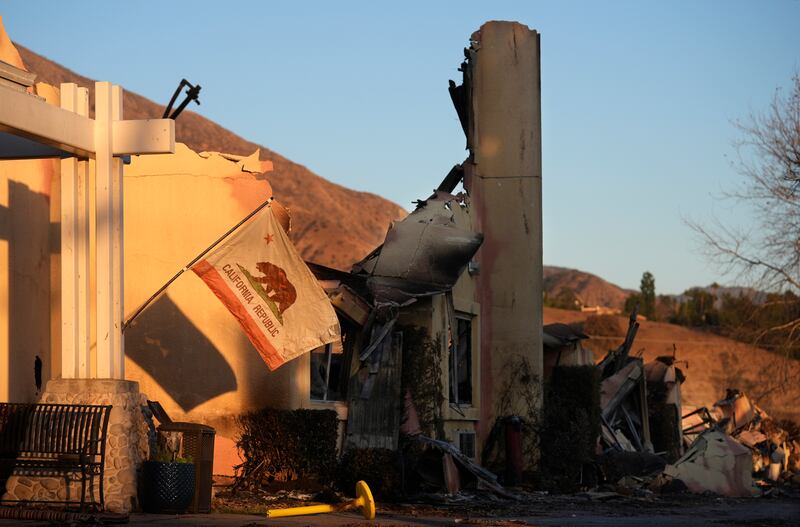 A California state flag hangs outside the charred remains of the Terraces at Park Marino assisted living facility in Pasadena, California (Chris Pizzello/AP)