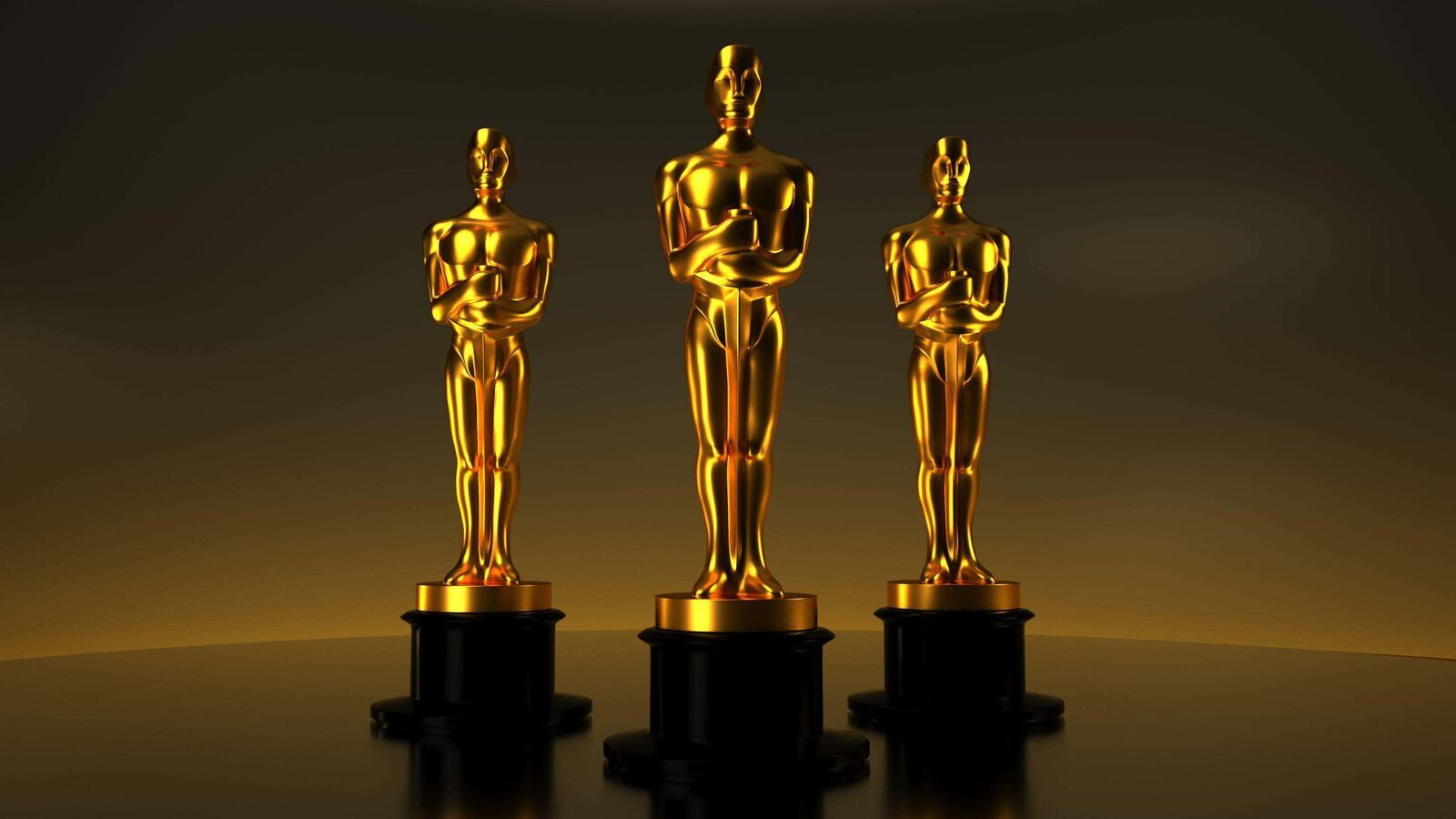 A photo of three Academy Award statuettes