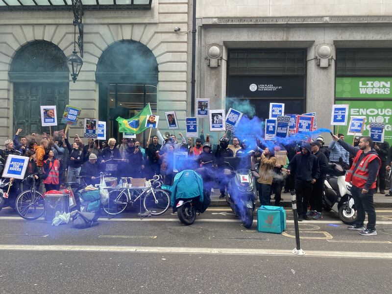 Deliveroo drivers protested outside the offices of London law firm White & Case as the Deliveroo AGM took place inside