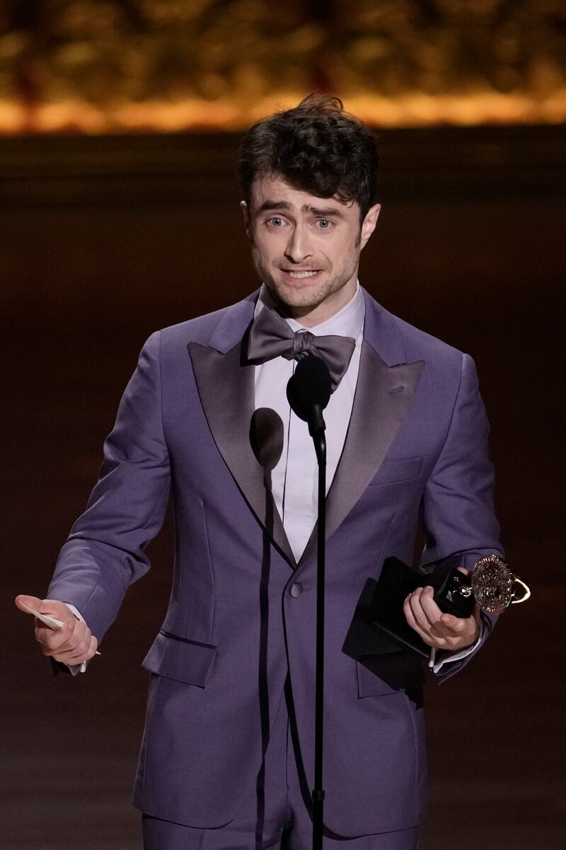 Daniel Radcliffe accepts the award for best performance by an actor in a featured role in a musical for Merrily We Roll Along (Charles Sykes/Invision/AP)