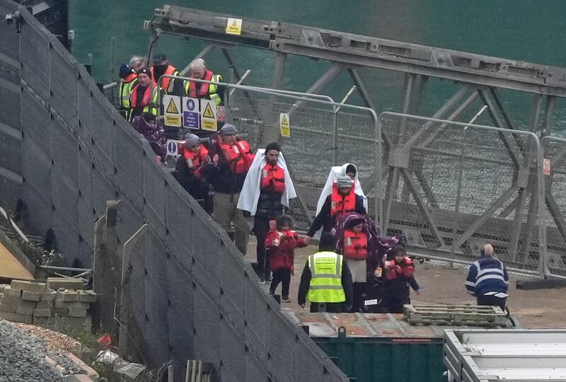 A group of people thought to be migrants, including young children, are brought in to Dover, Kent, from a Border Force vessel