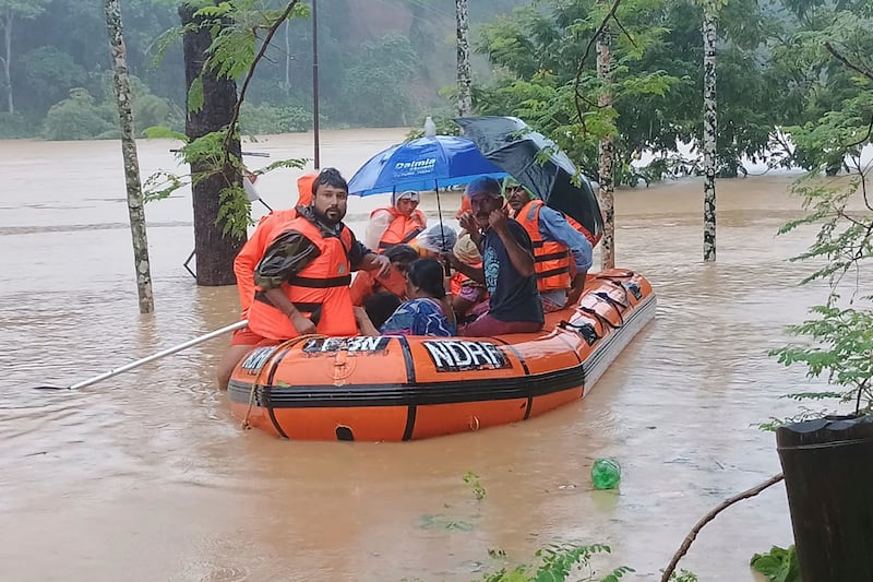 Rescuers transport people to safety in north-eastern Tripura state (National Disaster Response Force/AP)