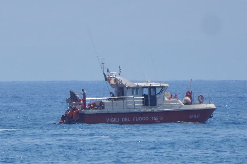 Rescue teams brought the bodies of the victims to shore in Porticello