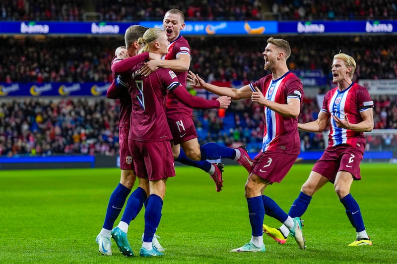 Erling Haaland, left, celebrates with team-mates (Fredrik Varfjell/NTB Scanpix via AP)