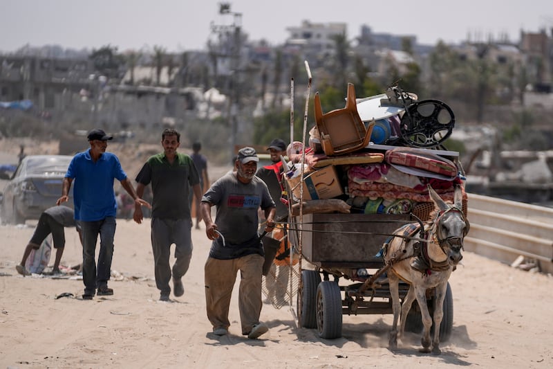 Palestinians displaced by the Israeli air and ground offensive on the Gaza Strip flee from parts of Khan Younis, following an evacuation order by the Israeli army (Abdel Kareem Hana/AP)