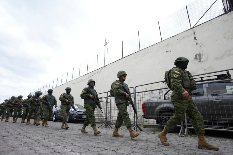 Police and soldiers prepare to enter El Inca prison to quell a riot in Quito (Dolores Ochoa/AP)