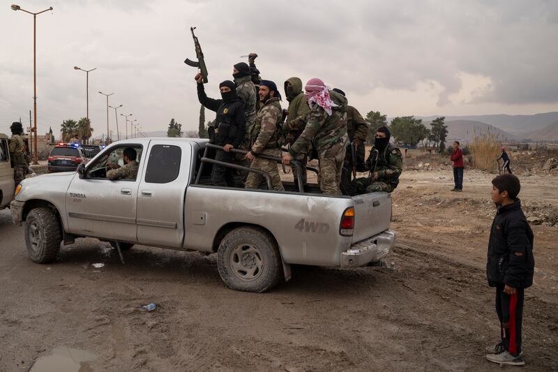 Members of the security forces of the newly formed Syrian government taking part in an operation to detain suspected militias of the ousted president Bashar Assad in Adra (Leo Correa/AP)