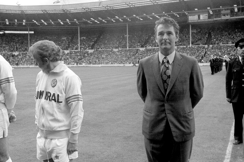 Leeds United captain Billy Bremner (l) looks away from Manager Brian Clough (r) as the teams line-up before the kick off